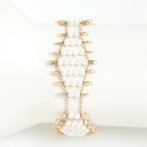 Kellan bracelet, featuring undulating rows of lustrous, white pearls, suspended on rows of 14k gold-fill wire and chain, and finished with a lobster clasp.  Approximately 7 inches in length.  