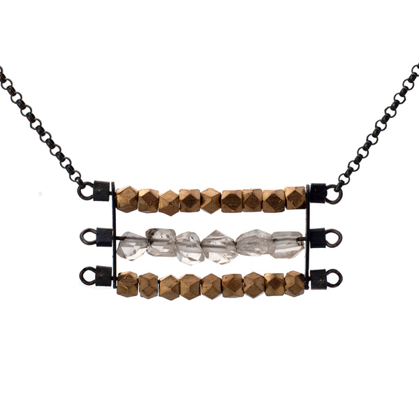 Abacus necklace with two rows of faceted brass beads and one row of clear Herkimer Diamonds, suspended horizontally on black oxidized sterling silver rungs, hanging from a black oxidized sterling silver chain.  Approximately 17" in length.