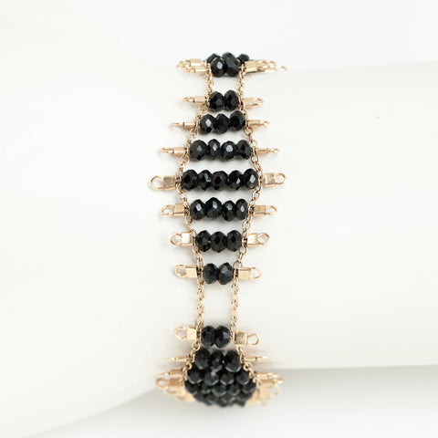 Kellan bracelet featuring rows of faceted Onyx beads, suspended on rows of 14k gold-fill wire and chain, and finished with a lobster clasp.  