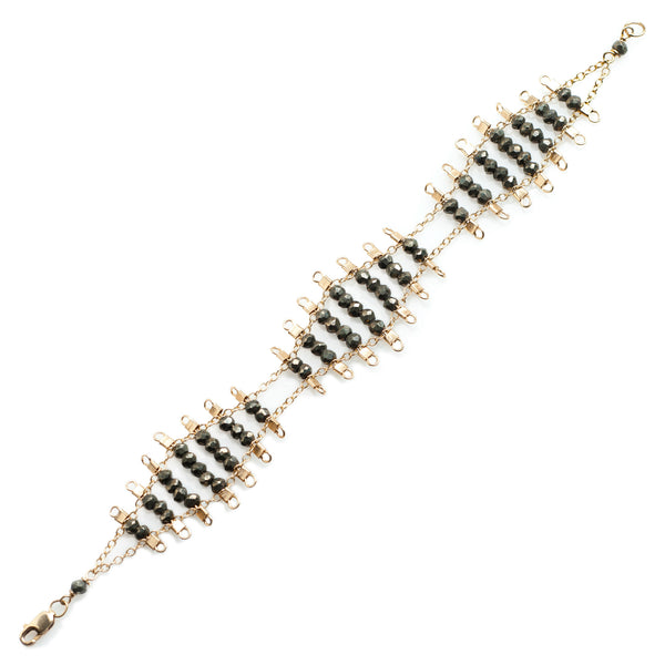 Kellan bracelet, featuring undulating rows of metallic, faceted pyrite beads, suspended on rows of 14k gold-fill wire and chain, and finished with a lobster clasp.  Approximately 7 inches in length. 