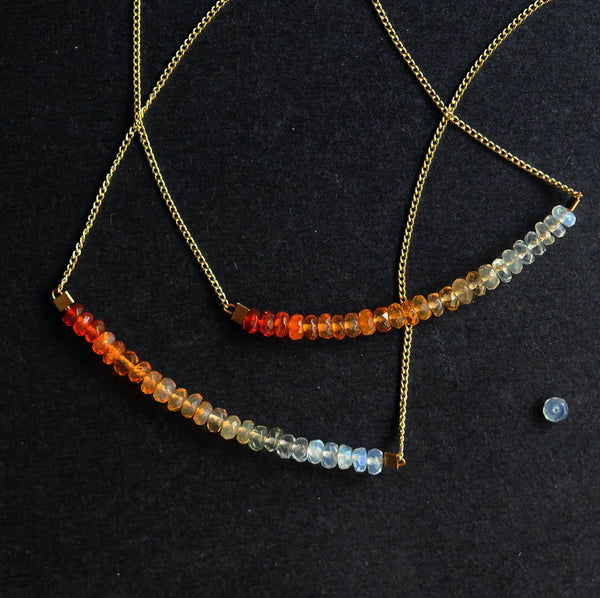 Two thin, gold chain necklaces strung with 2 inches of Mexican fire opal in milky to orange ombre tones.